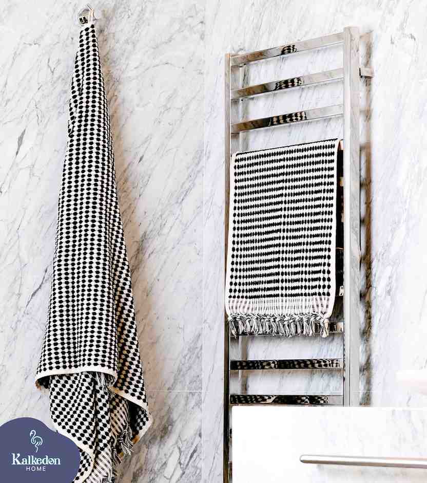 black pom pom bath towel hanged