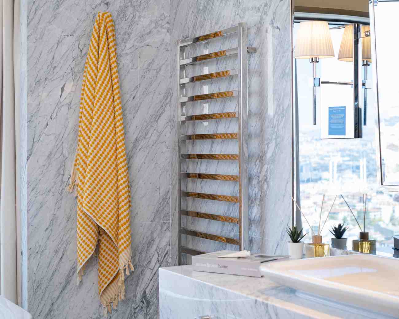 mustard pom pom bath towel hanged