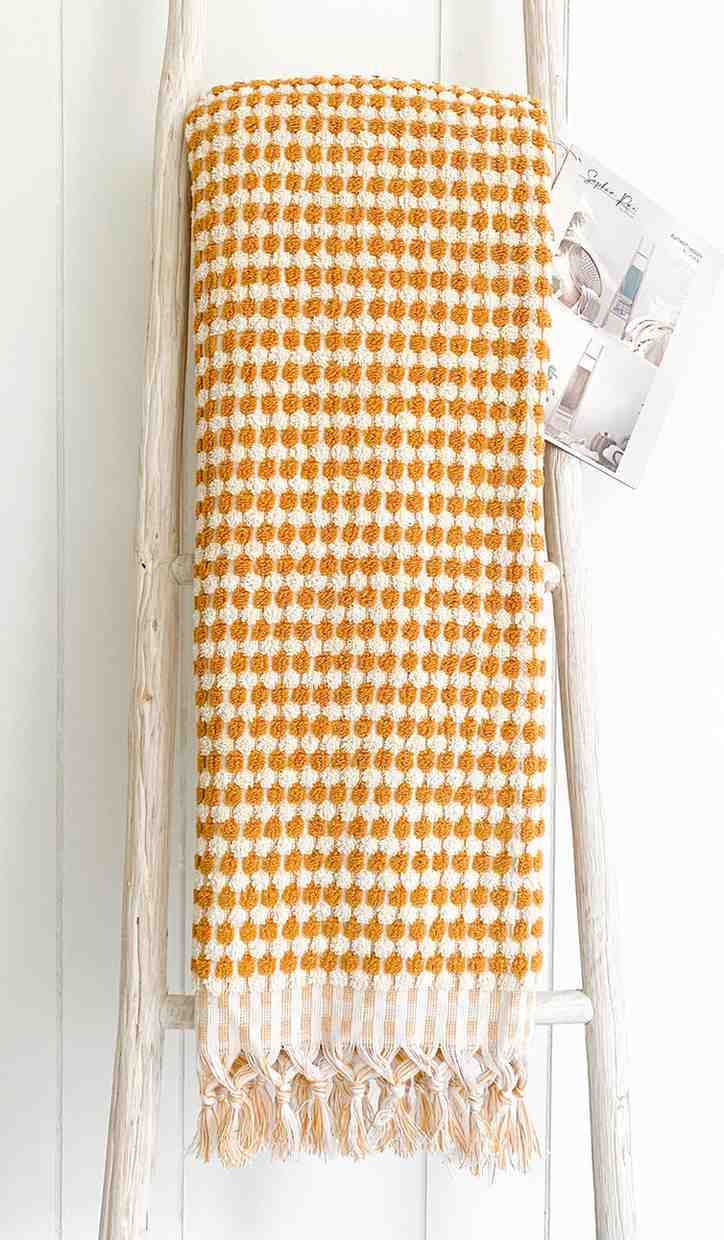 mustard pom pom bath towel