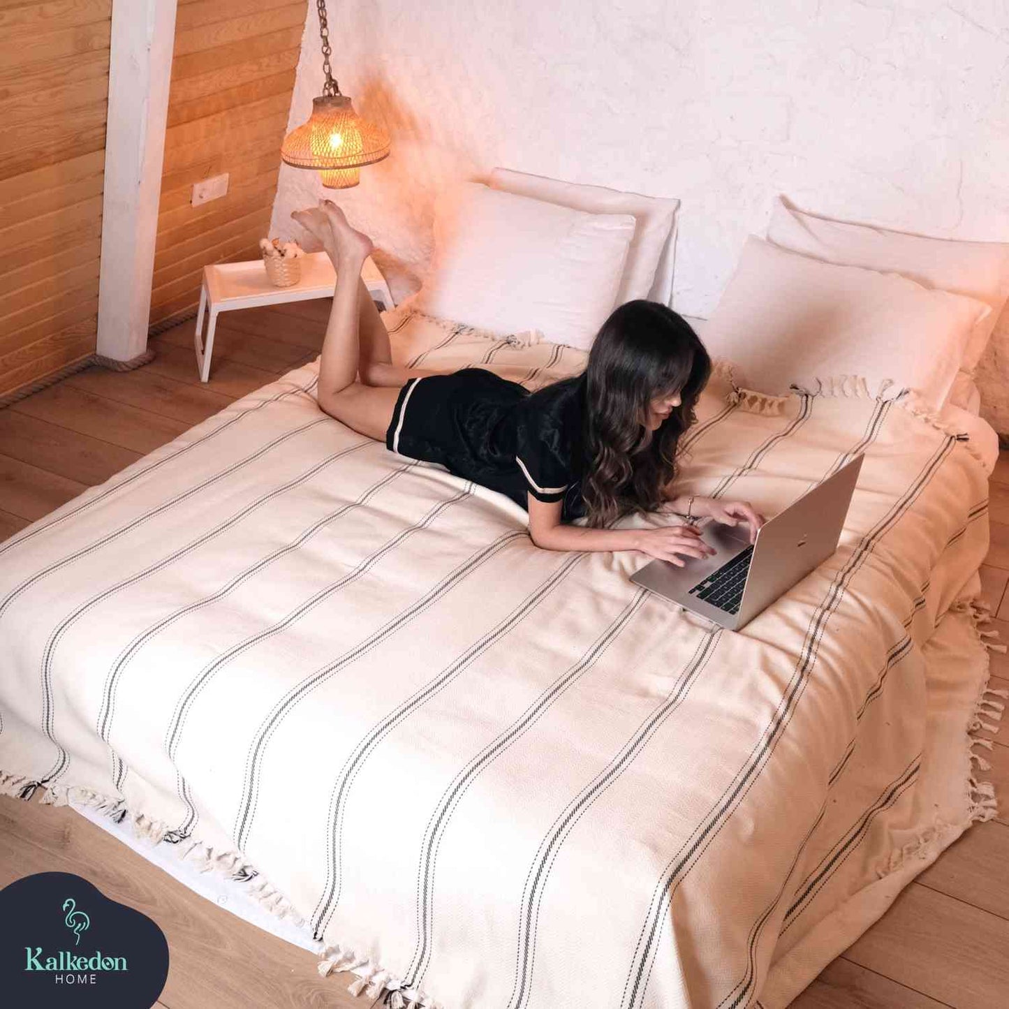 Queen-sized Turkish Muslin Cotton throw blanket on a bed.
