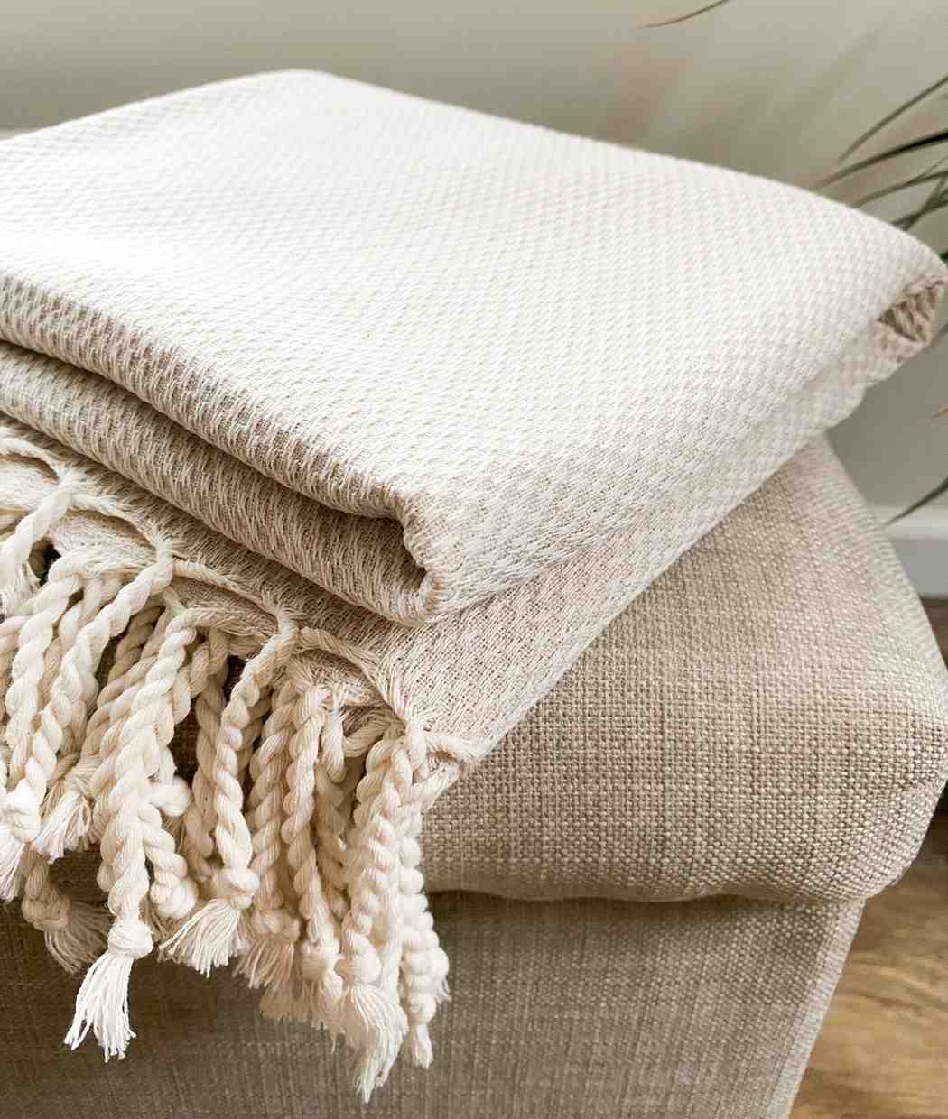 Eco-friendly jacquard throw blanket crafted from organic cotton.