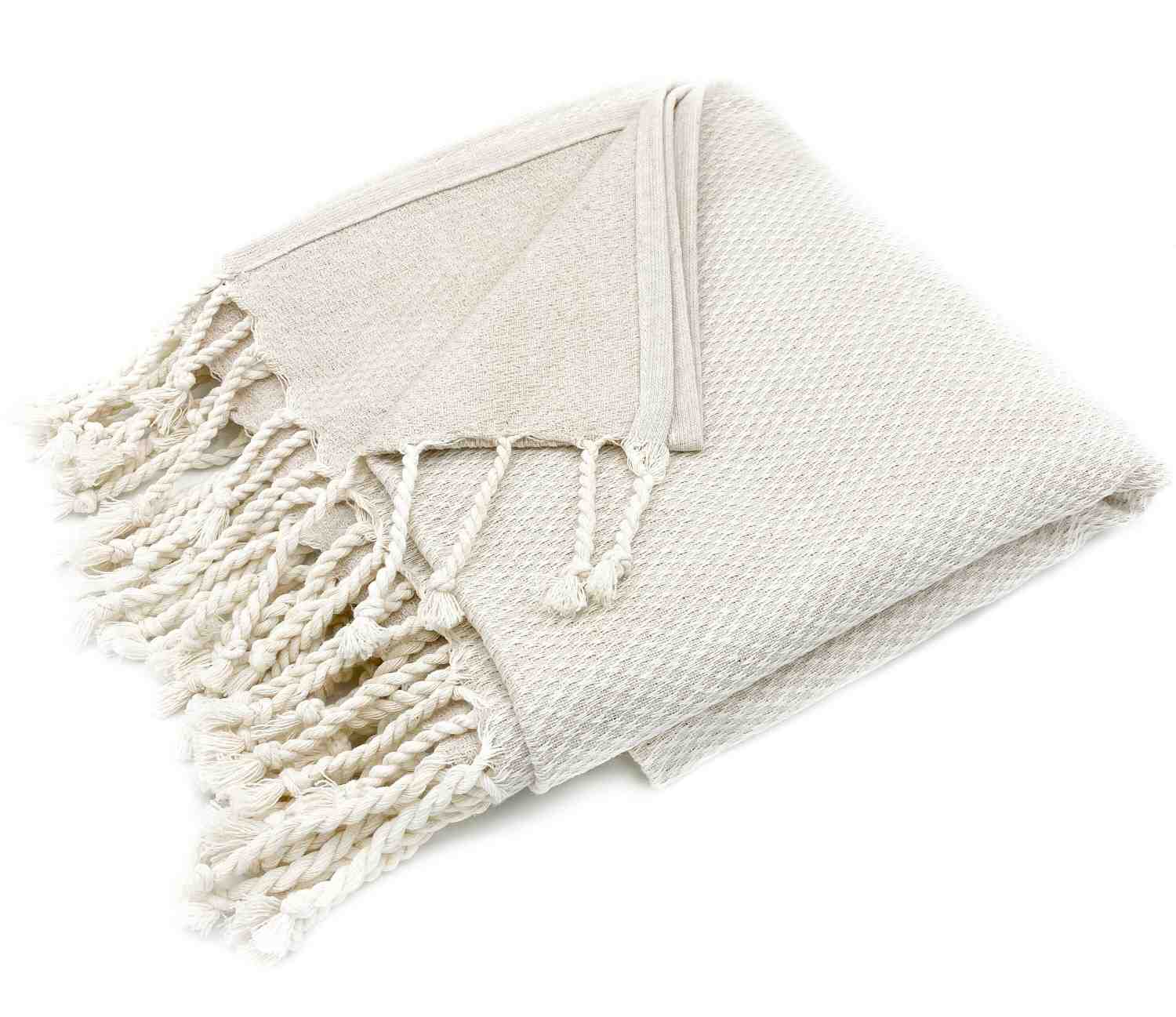 Sustainable jacquard blanket in off-white for rustic farmhouse style.