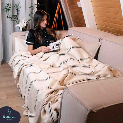 Turkish Muslin Cotton throw blanket draped on a sofa